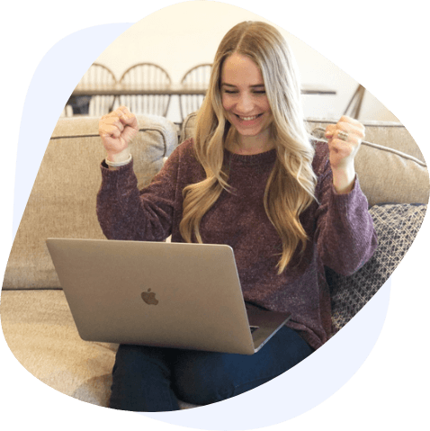 blonde woman celebrating laptop