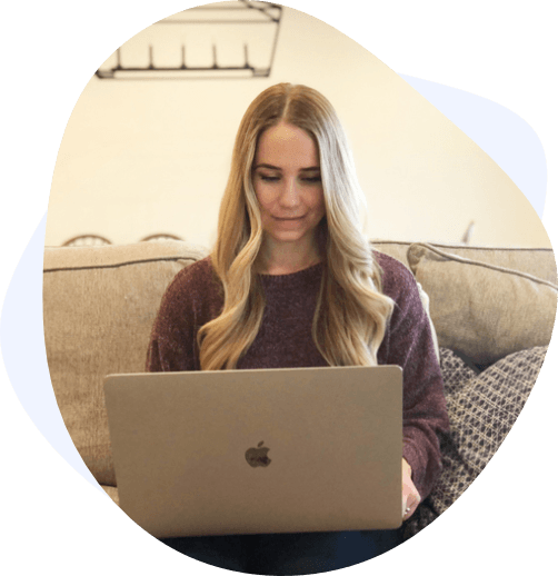 blonde woman laptop couch